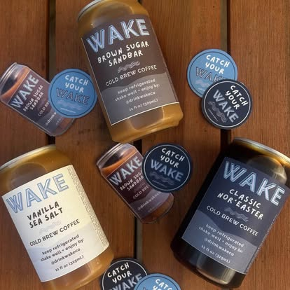 WAKE lineup and Catch Your WAKE stickers on a wooden deck